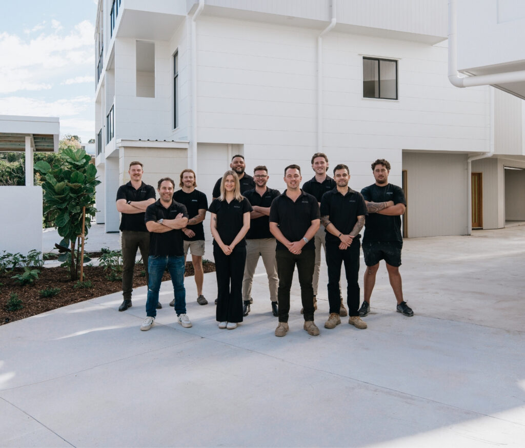 Image of AKAM team in front of completed construction site